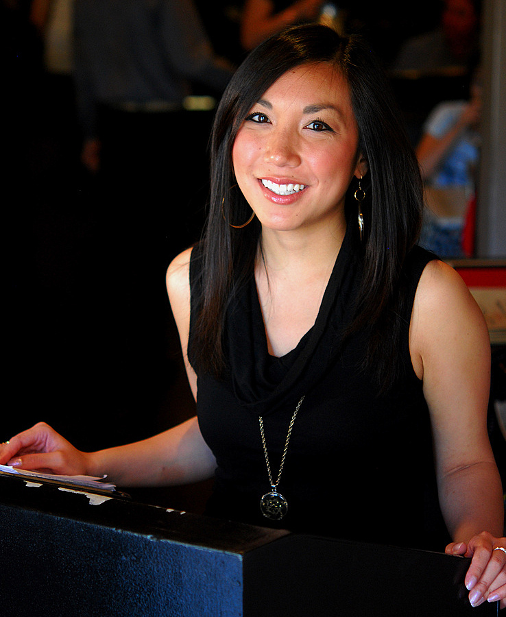 hostess at restaurant in black dress smiling smile