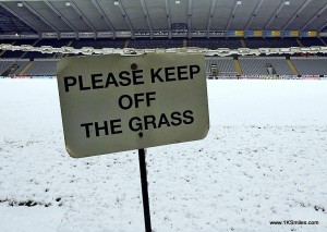football in snow keep of grass sign